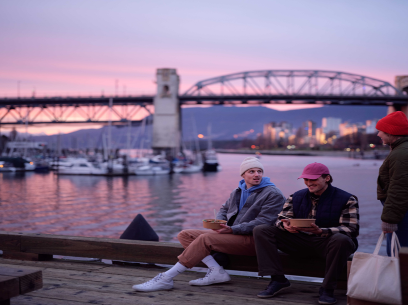A group of people sitting on a bench by water

AI-generated content may be incorrect.